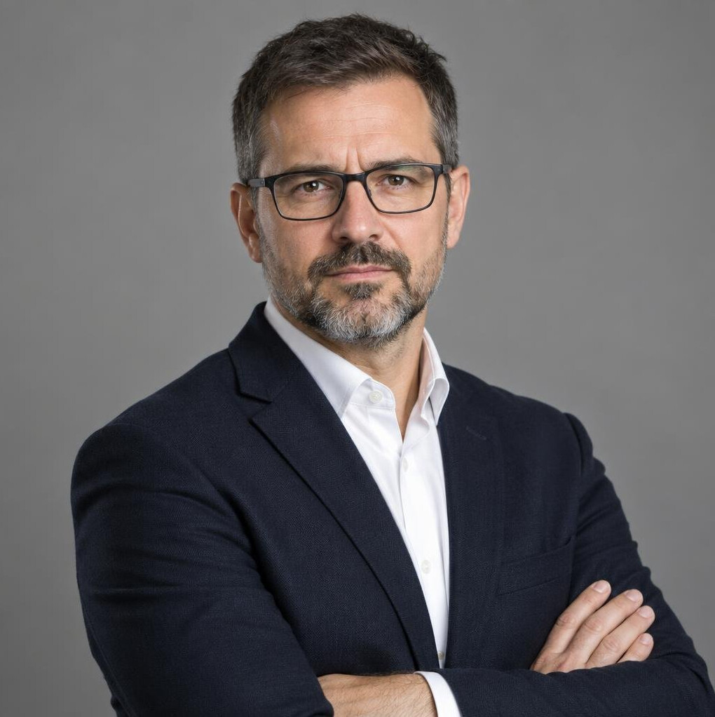 Studio portrait of a serious middle-aged bearded writer in a dark blazer